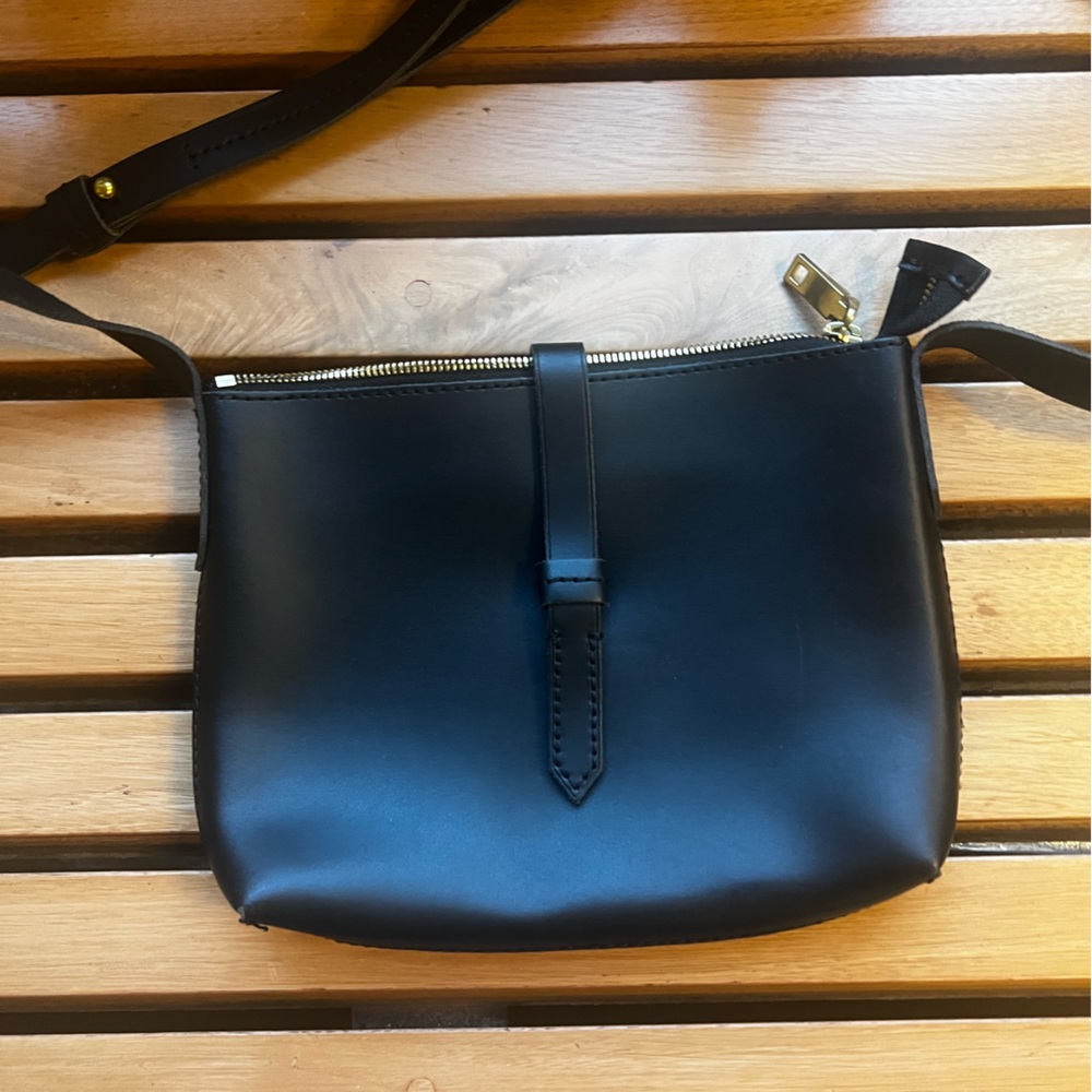 J.Crew NWOT - Black leather cross body. Adjustable strap. Snap closure.
